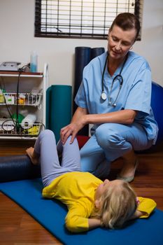 Physiotherapist giving physical therapy to the girl