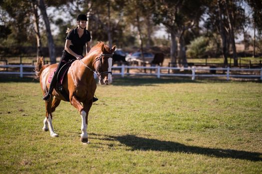 Jockey riding horse at equestrian center