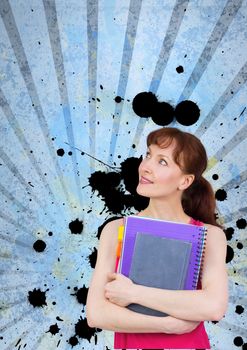 Young student woman holding notebooks against blue splattered background