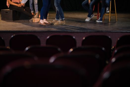 Actors practicing play on stage in theatre
