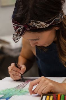 Woman drawing on book in drawing class