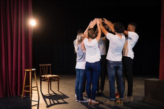 Actors team forming their hands stacked