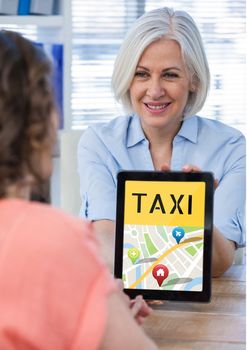 Woman holding a tablet with a taxi app