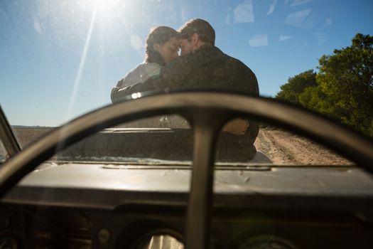 Romantic couple seen through off road vehicle windshield