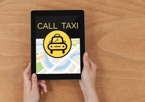 Person holding a tablet with a taxi app