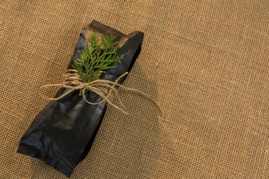 Overhead of christmas gift wrapped with jute rope