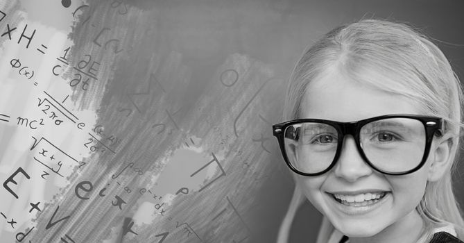 Girl with glasses next to equations theory on blackboard