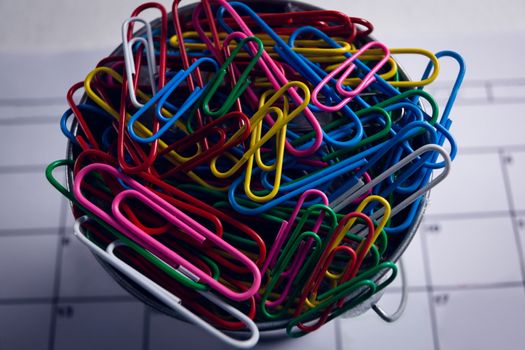 Colorful paper clips in bucket