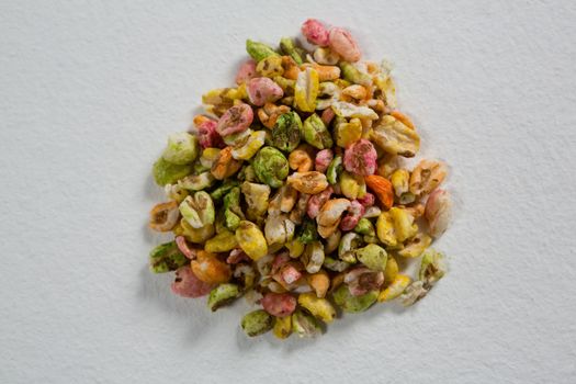 Multi-colored granola on white background