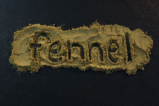 Fennel powder forming text fennel on black background