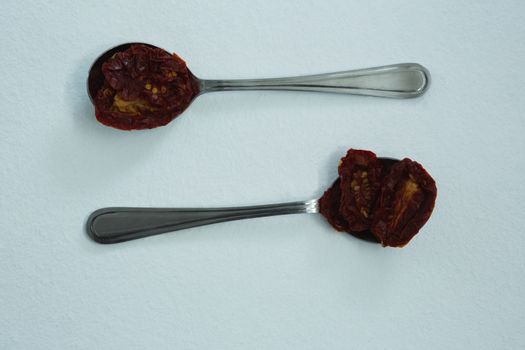 Dried red chili peppers in spoon