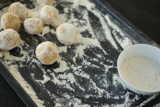 Close up of dough with flour on baking sheet