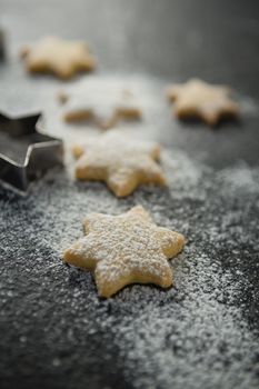 Close up of flour on star shape unbaked cookies
