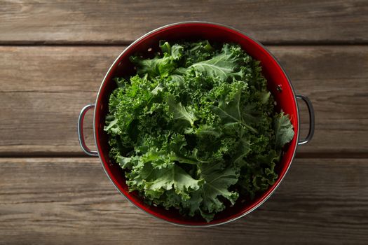 Overhead view of kale in colander on table