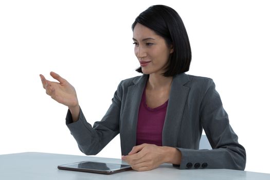 Businesswoman gesturing at desk