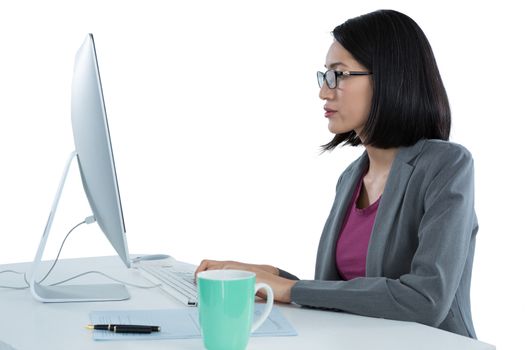 Businesswoman working on desktop pc