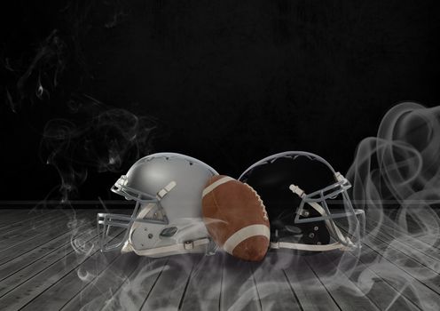 American football and helmets in smoke
