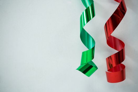 Red and green streamers on white background