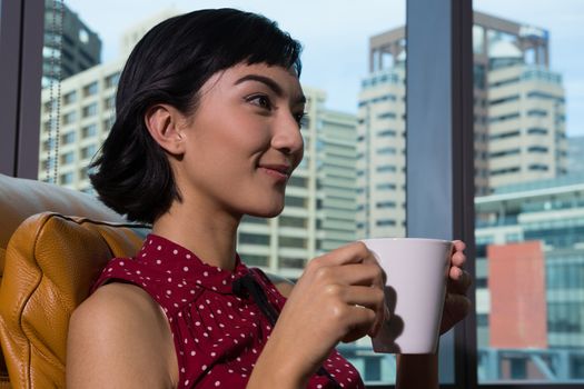 Female executive having coffee