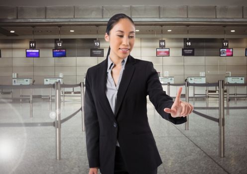 Airport businesswoman touching air in front of airport queue barriers