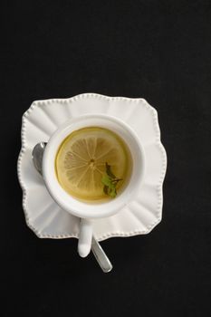 Cup of tea with lemon slice and spoon
