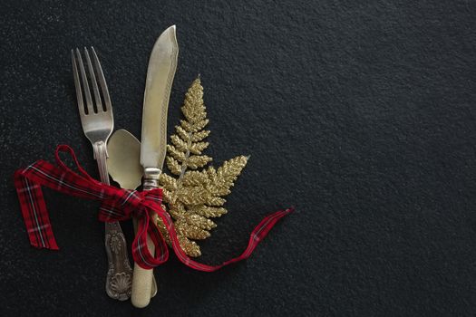 Cutlery with christmas ornament tied up with ribbon