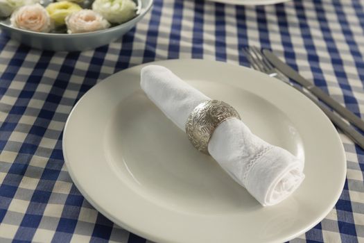 Rolled up napkin arranged on plate