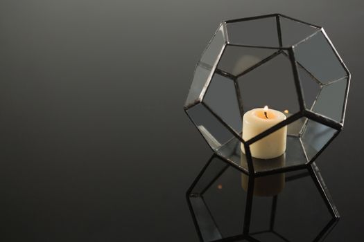 Lit candle on candle holder