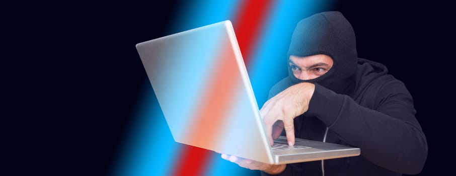 Hacker using laptop to steal identity at desk