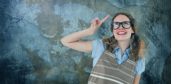 Composite image of geeky hipster woman pointing up 