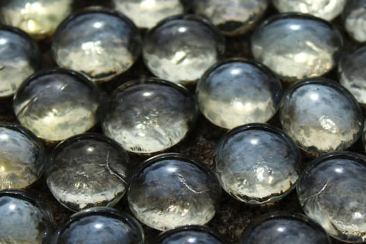 many glass beads on stone floor