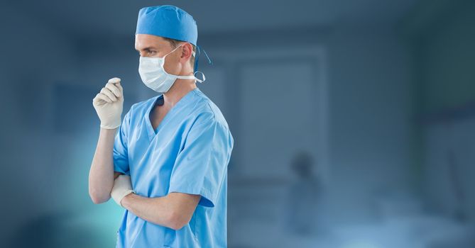 Male doctor thinking and wearing surgical mask