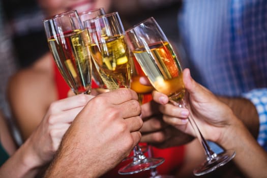 Friends toasting champagne glass in nightclub