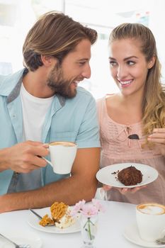 Happy couple enjoying coffee and cake