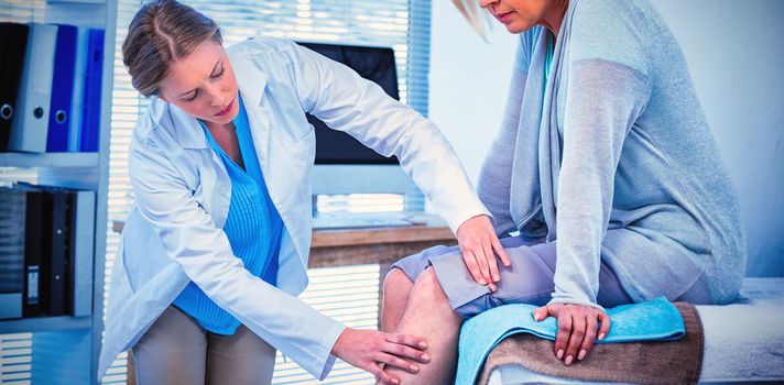 Doctor examining patient knee