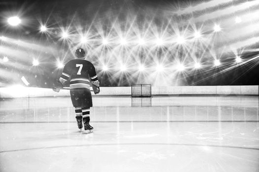 Composite image of rear view of player holding ice hockey stick
