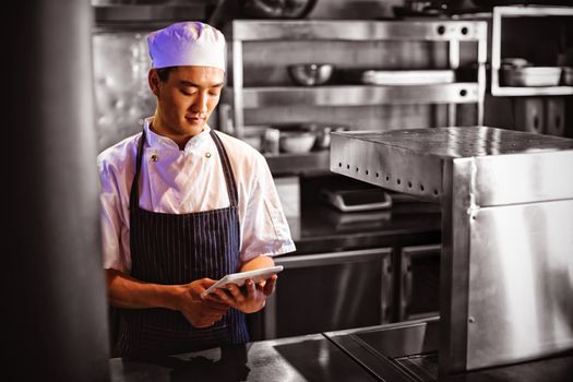 Chef using digital tablet in the commercial kitchen