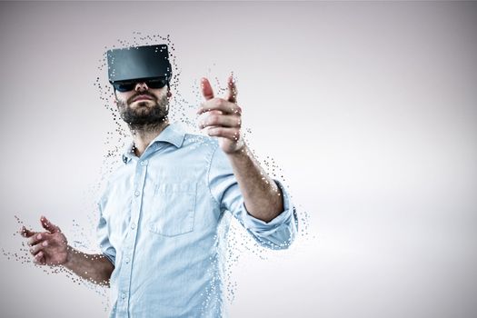 Composite image of low angle view of man using oculus rift headset