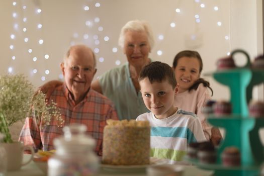 Multi-generation family celebrating birthday of grandson