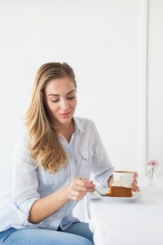 Pretty blonde having cake and coffee
