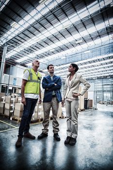 Warehouse managers discussing with the worker