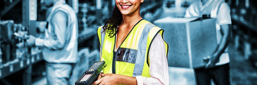Portrait of female warehouse worker standing with barcode scanner