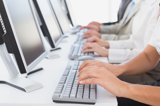 Employees typing on their computers