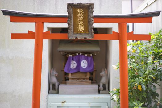 Shinto neighborhood sanctuary with torii portal