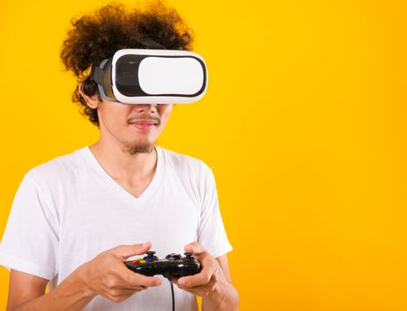 Asian handsome man with curly hair play game he using virtual re