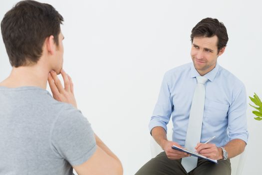 Well dressed male doctor in conversation with patient