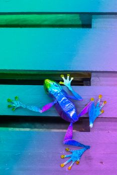 Neon colored vibrant metallic garden decoration frog with copy space
