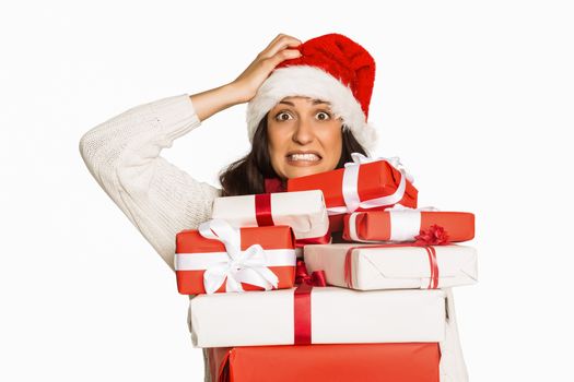 Shocked woman with christmas presents