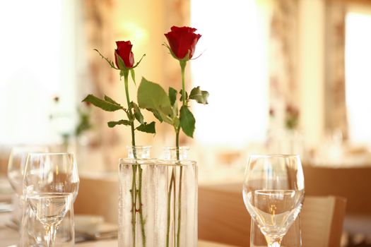 red roses on table set for guest to arrive