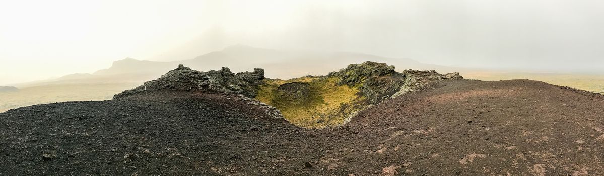 Snaefellsness national park in Iceland panorama from top of volcano during foggy day black and red rock